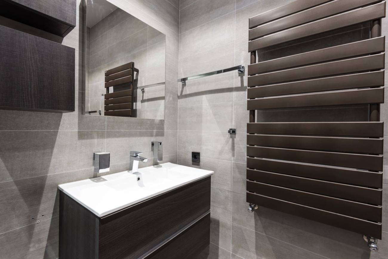 Sèche-serviettes à eau au design vertical dans une salle de bains rénovée